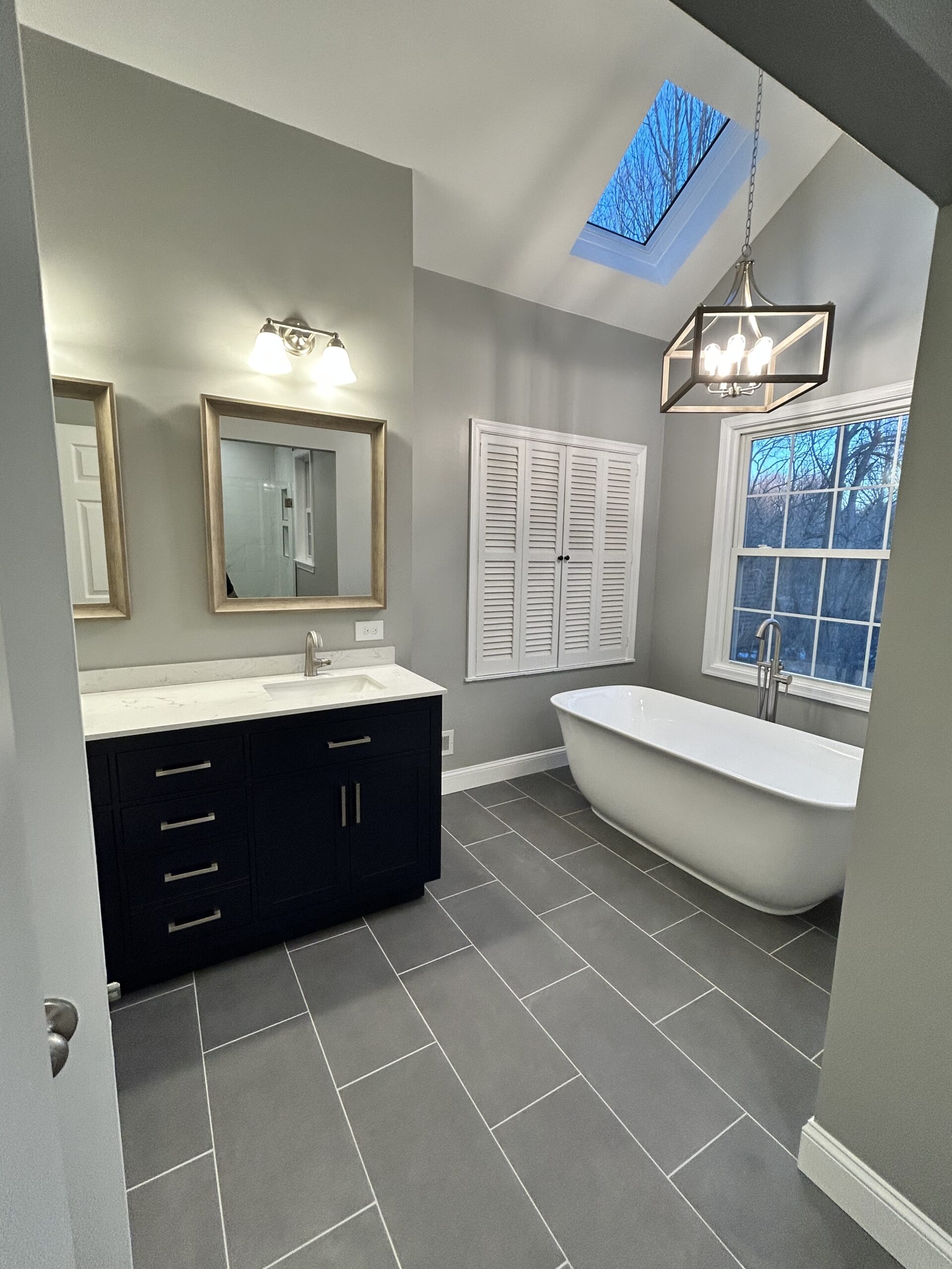 Master bathroom with freestanding bathtub and chandelier