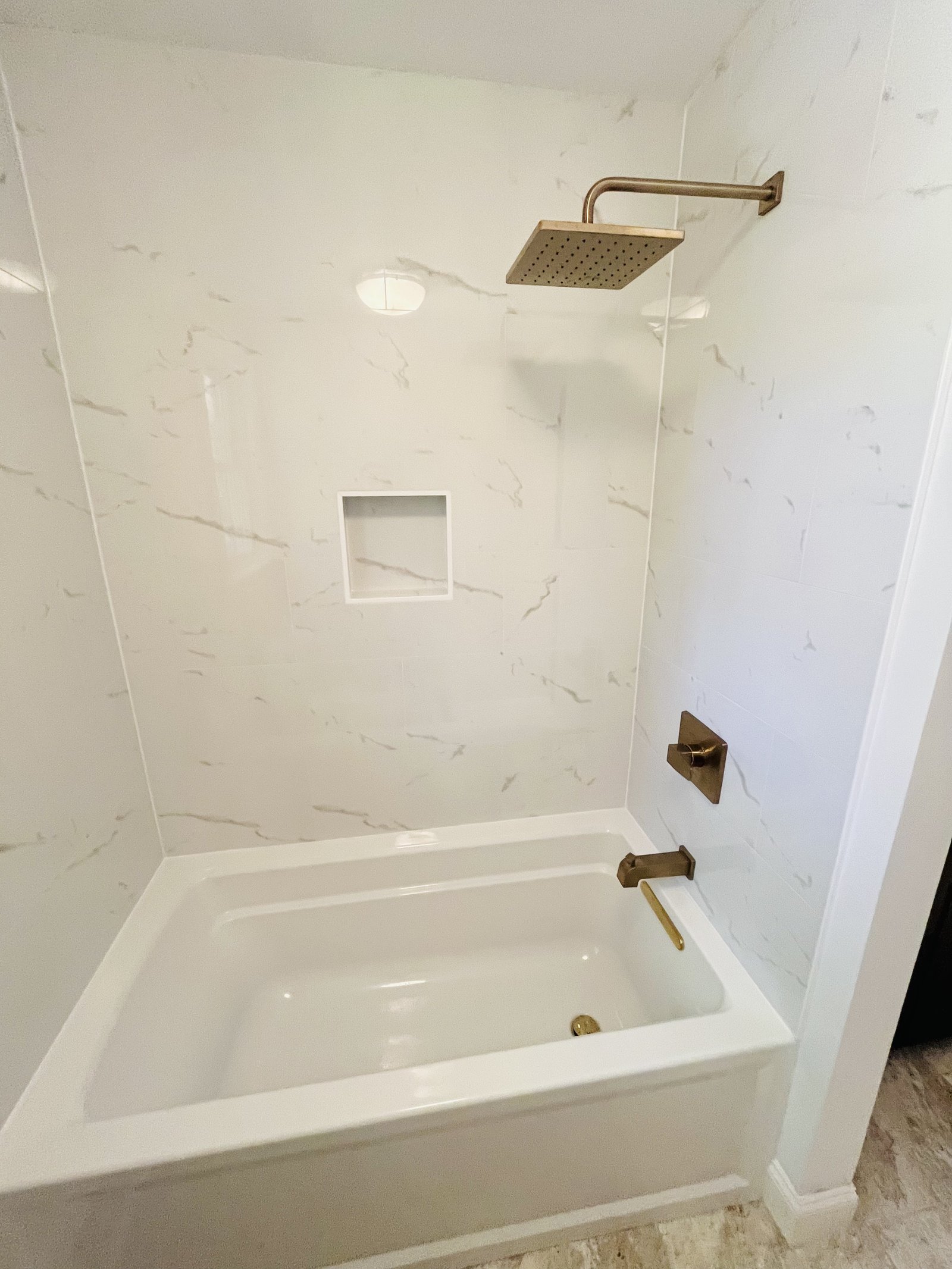 Tub shower with gold fixtures West Chester
